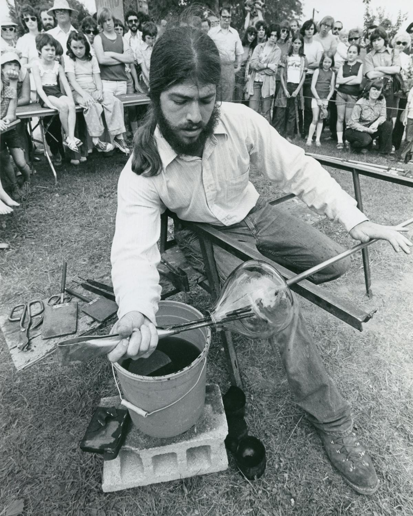 Glass artist Josh Simpson demonstrates glassmaking techniques at the 1974 ACC Northeast Craft Fair held in Rhinebeck, New York.