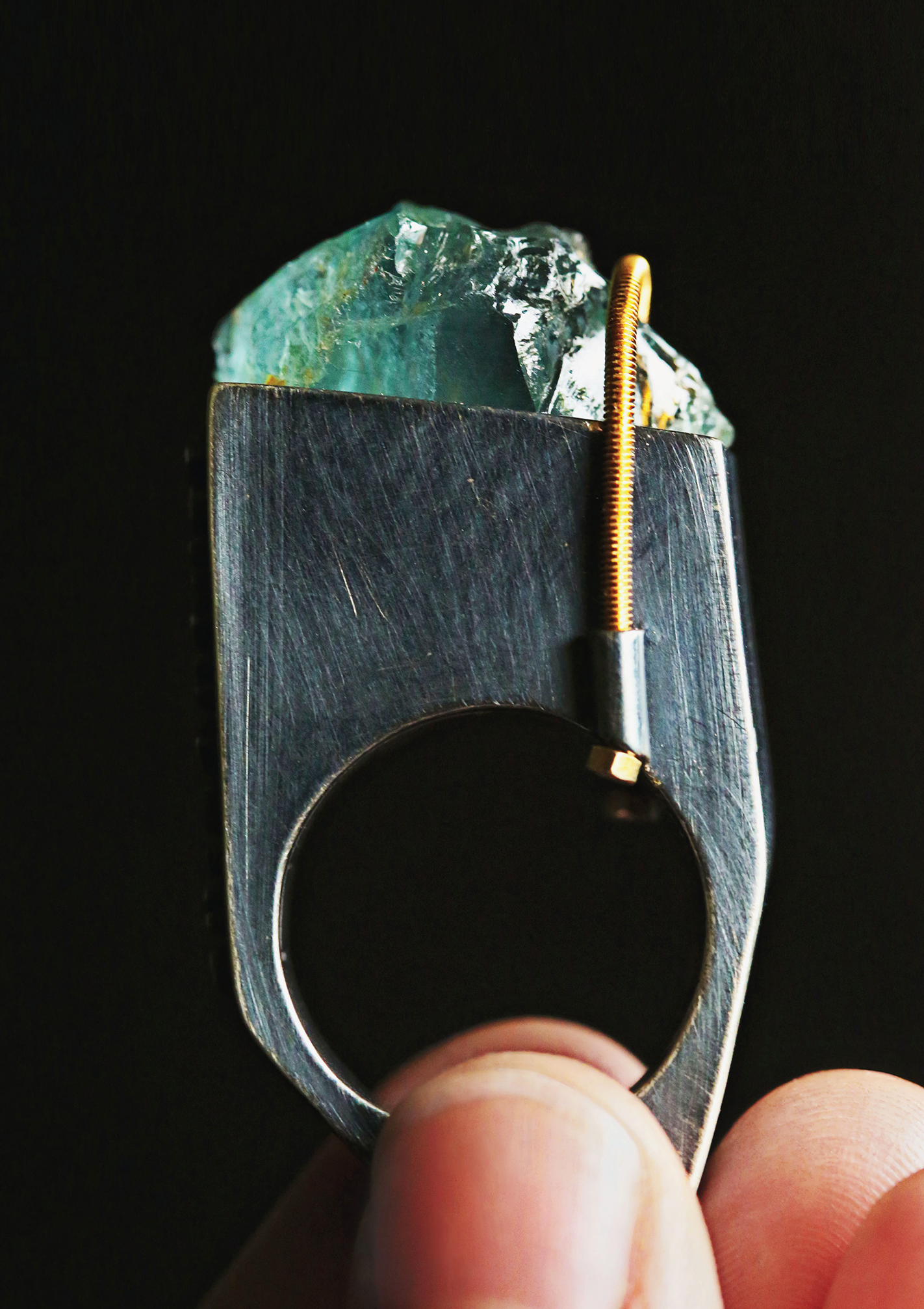 Chunky aquamarine affixed to sterling silver ring with prominent bolt
