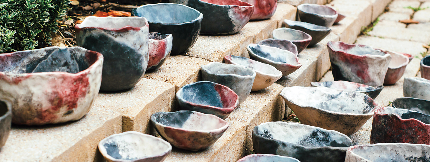 Handmade clay vessels arranged on steps