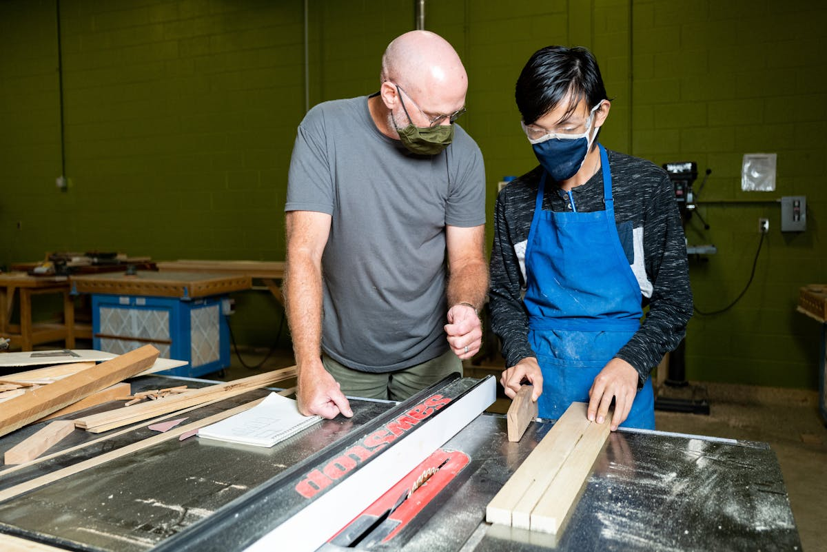Aaron Beale with a craft student.