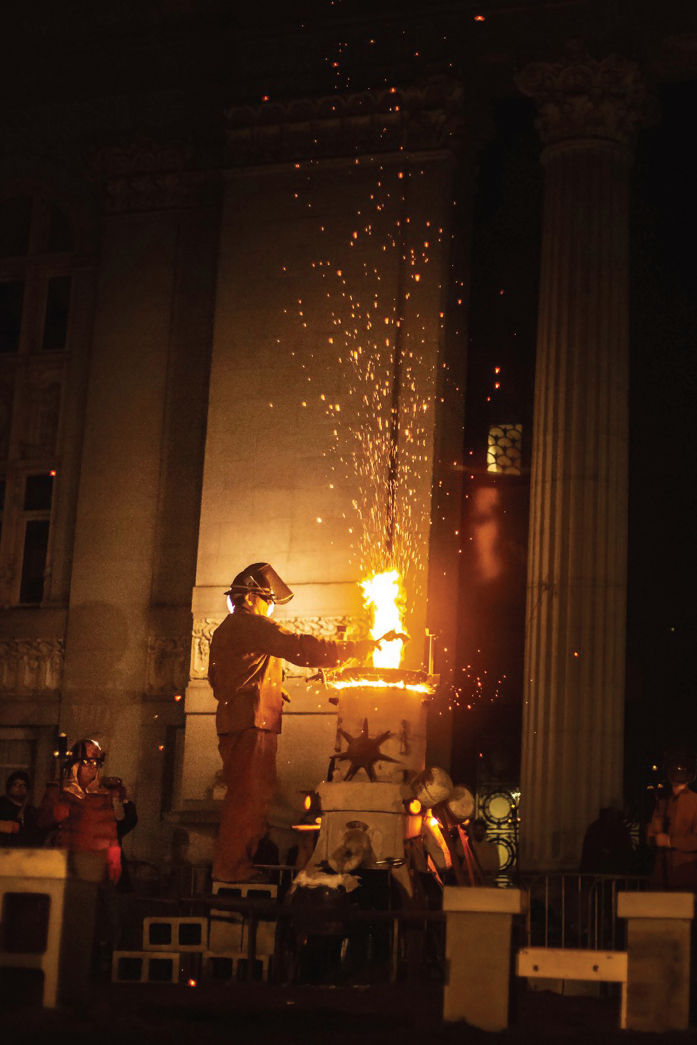 James Brenner places a gun over his iron furnace to begin the process of melting it