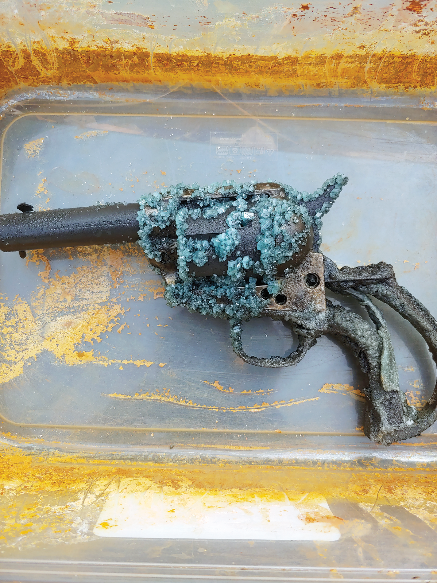 Blue-tinged iron sulfate crystals, the first stage in ink making, form on the gun.