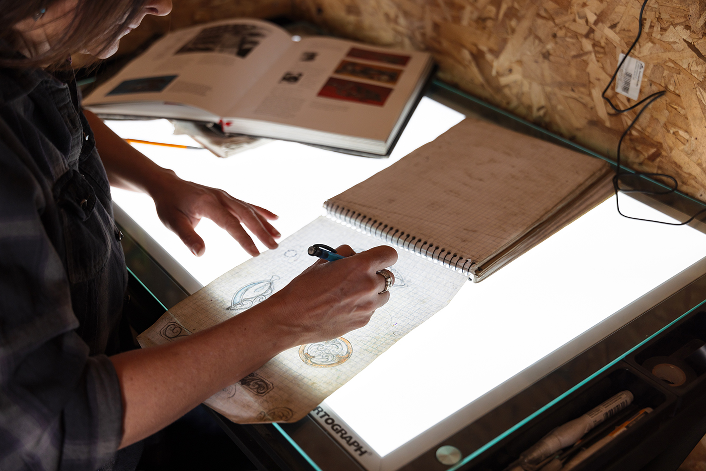 Amy Erickson sketches a new design at her light table.