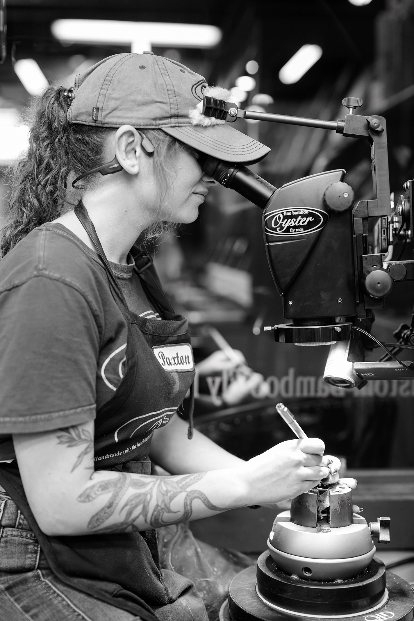 An in-house engraver at Oyster Bamboo works on a seat for a fly rod reel.