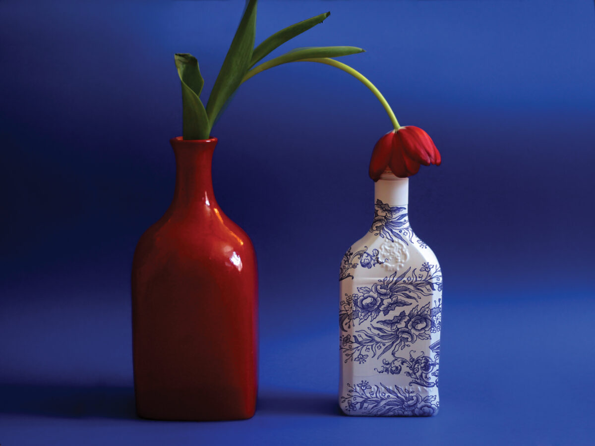 Two ceramic vessels and rose