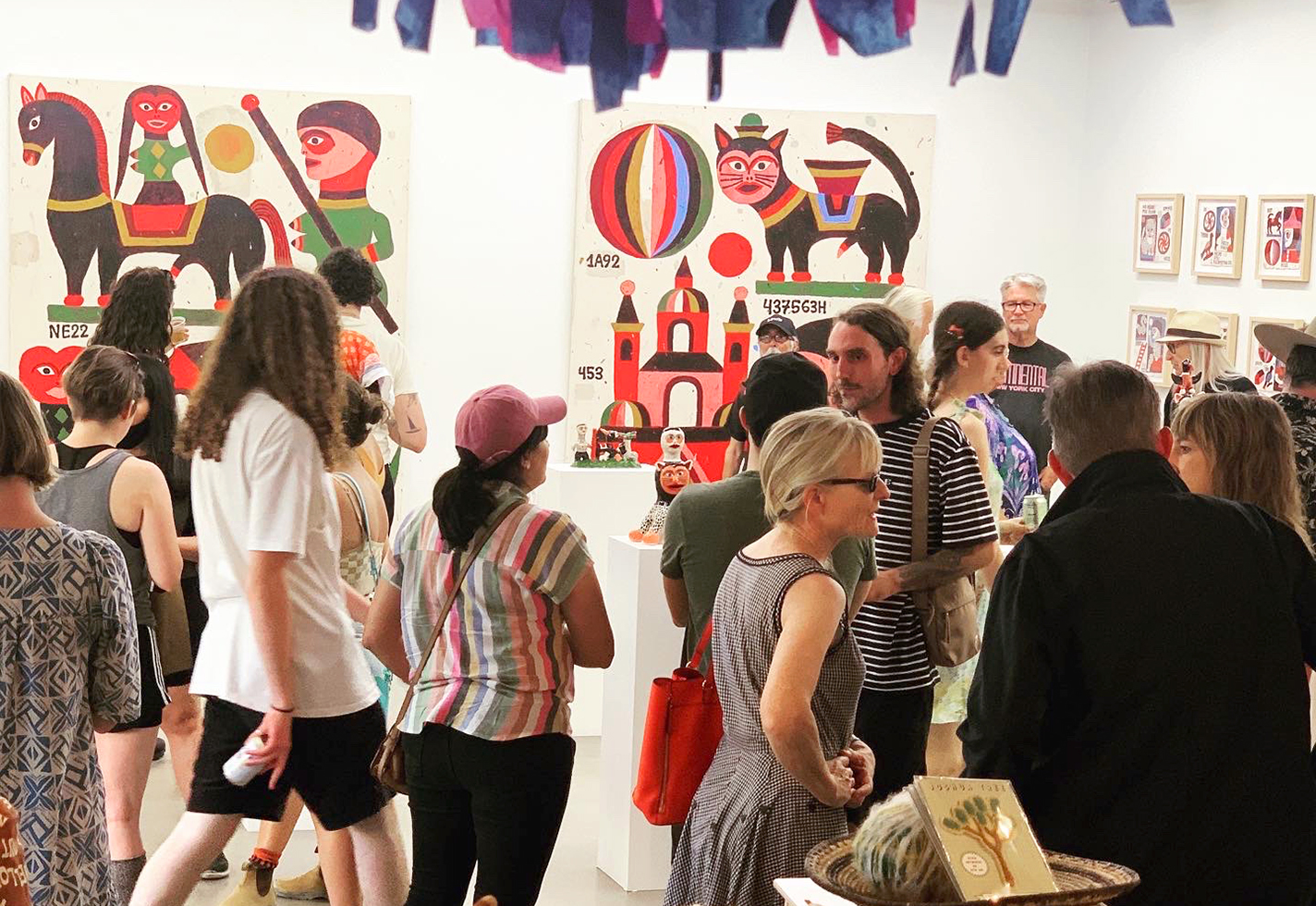 A crowd gathers in a gallery.