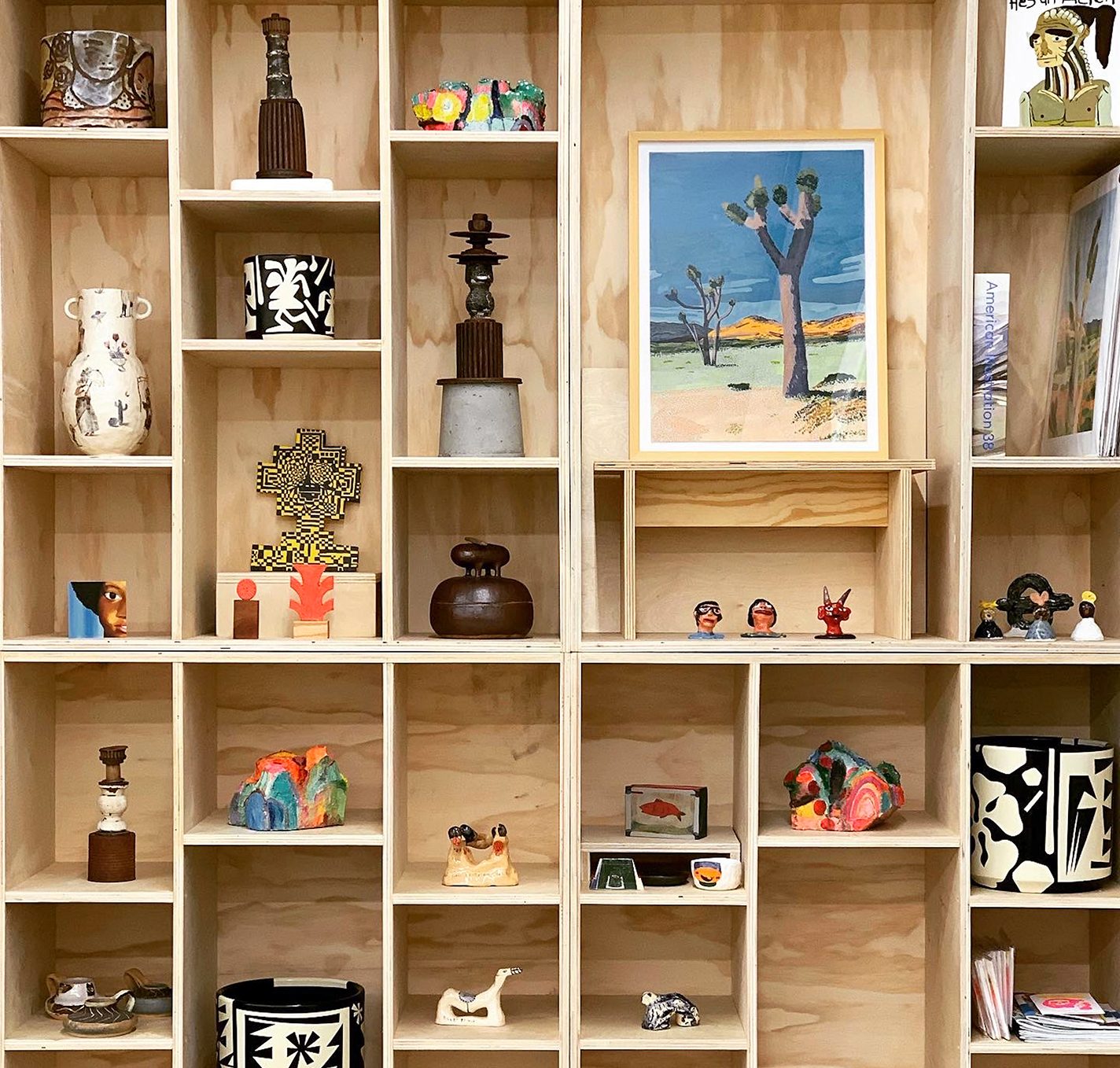 Cabinet wall filled with small sculptures and other pieces of art