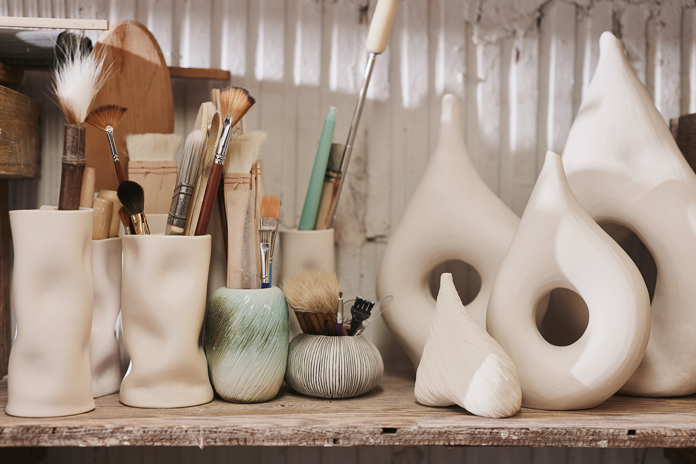 Brushes and tools in Kate Pak's porcelain vessels.