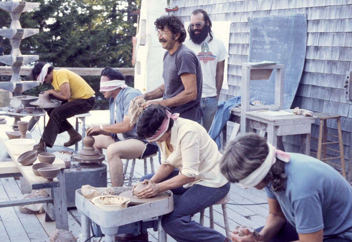 Blindfolded potters compete in a wheel-throwing contest, 1976.