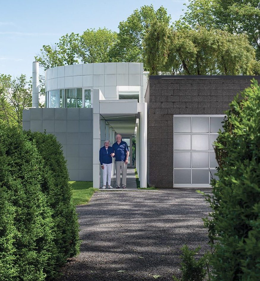 Sandy and Lou Grotta standing in front of their house.