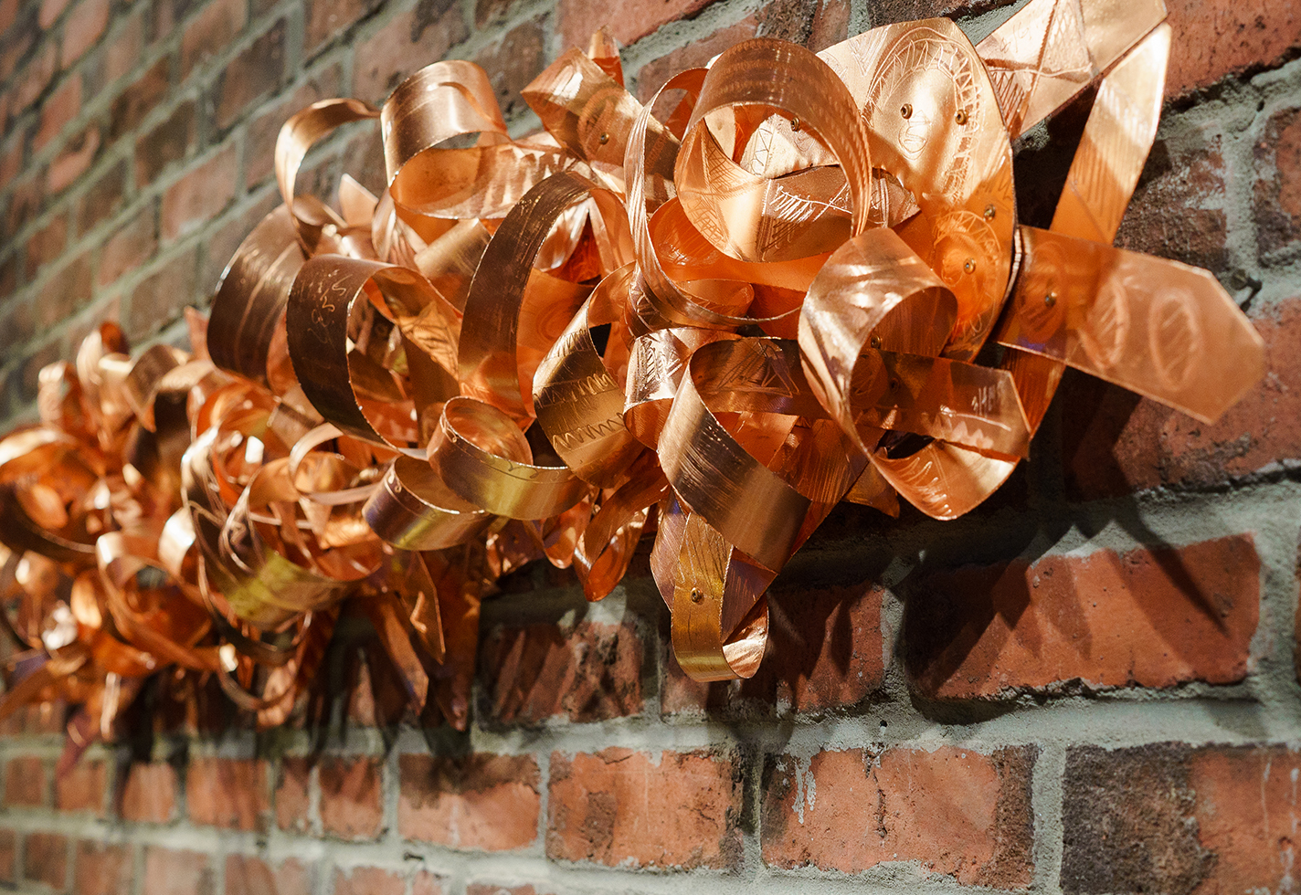 Copper wall-mounted sculpture.