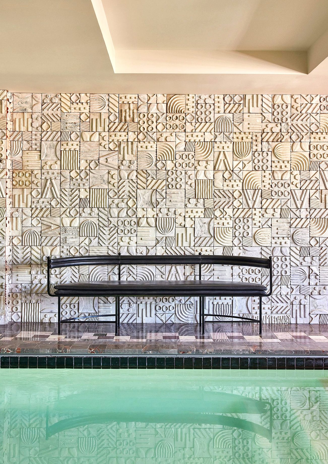 Medansky's ceramic pool wall installation with view of the pool