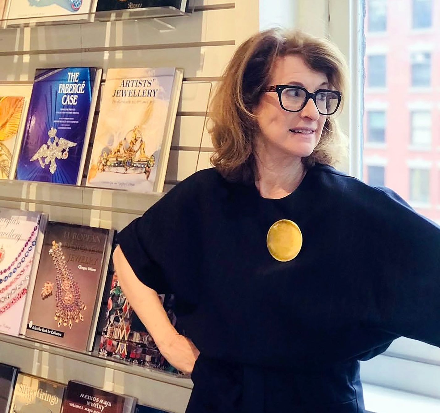 Founder Karen Davidov wearing a large gold brooch.