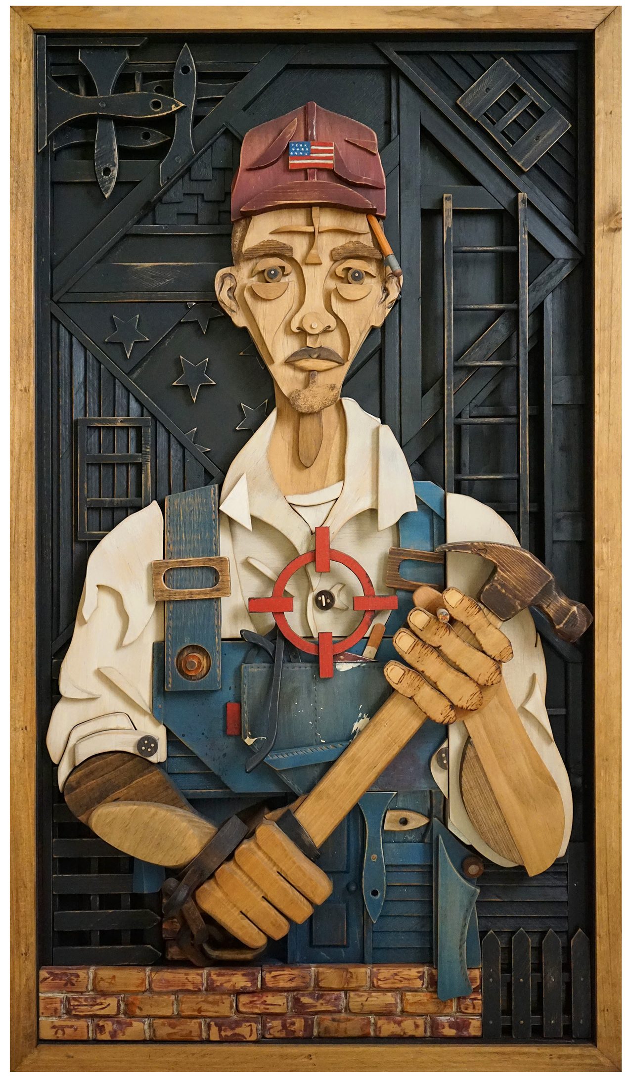 Wood collage portrait depicting a black man wearing overalls and a baseball cap and holding a hammer.