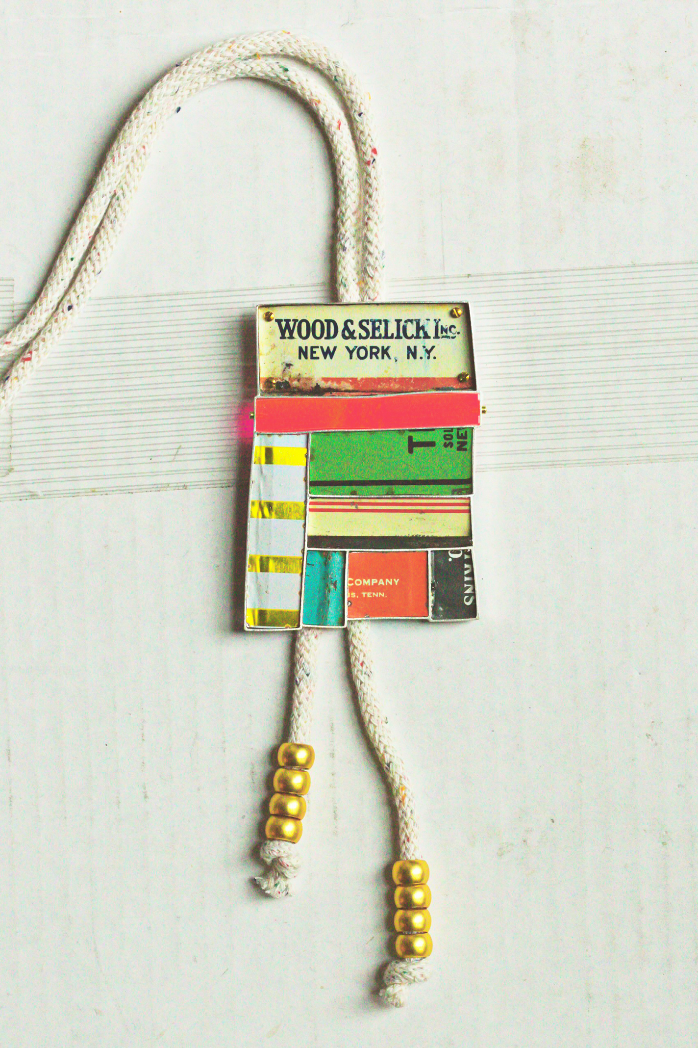 Bolo pendant made of deconstructed vintage metal tins on an adjustable cotton cord